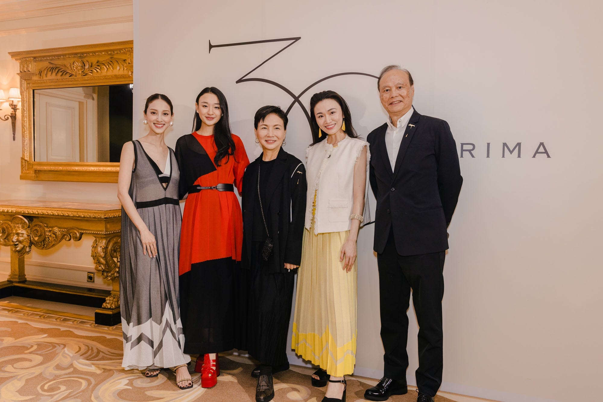 Anteprima guests gathered beneath the anniversary presentation backdrop
