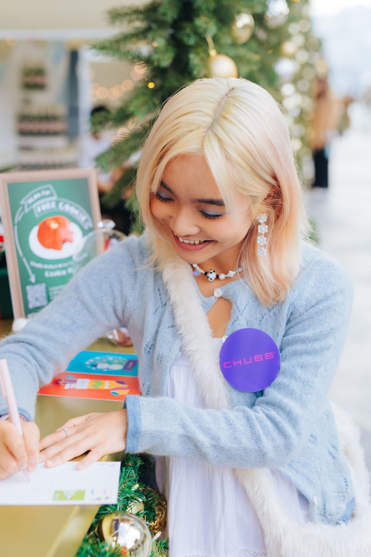 Guest smiling beside the Chubb festive market display