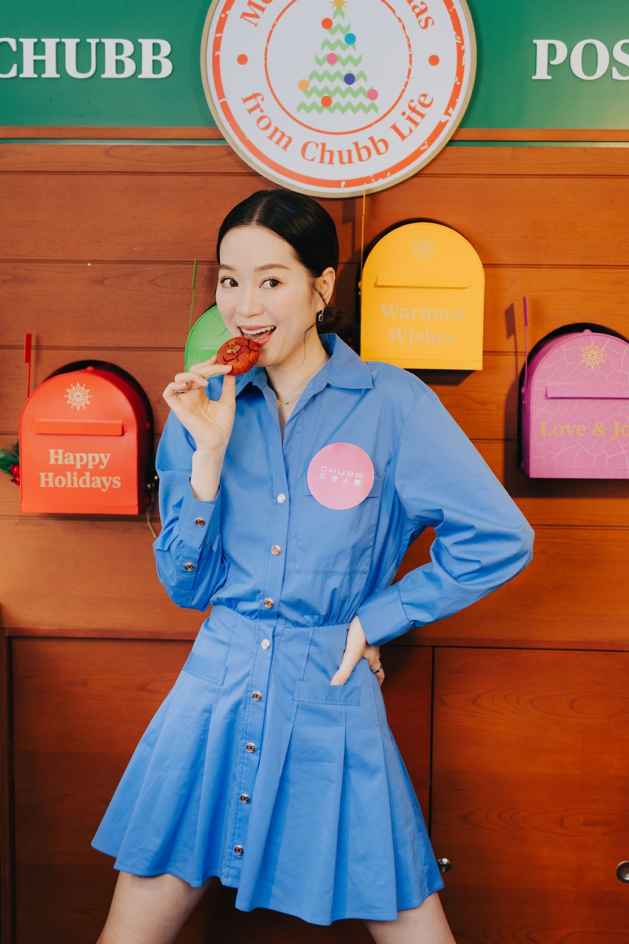 Guest holding a pastry in front of the Chubb Post display