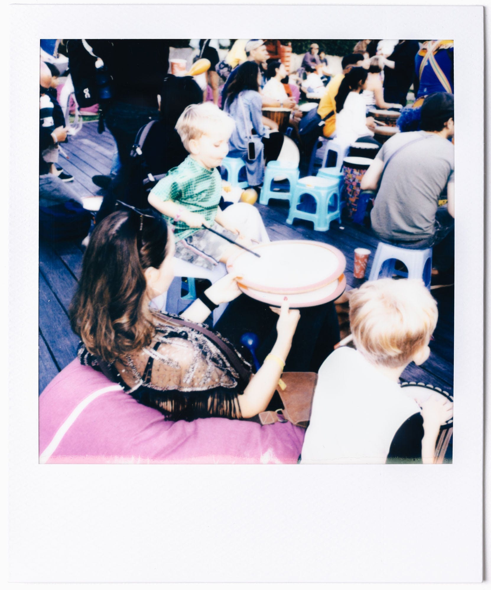 Family moment in the Clockenflap crowd captured on Polaroid film