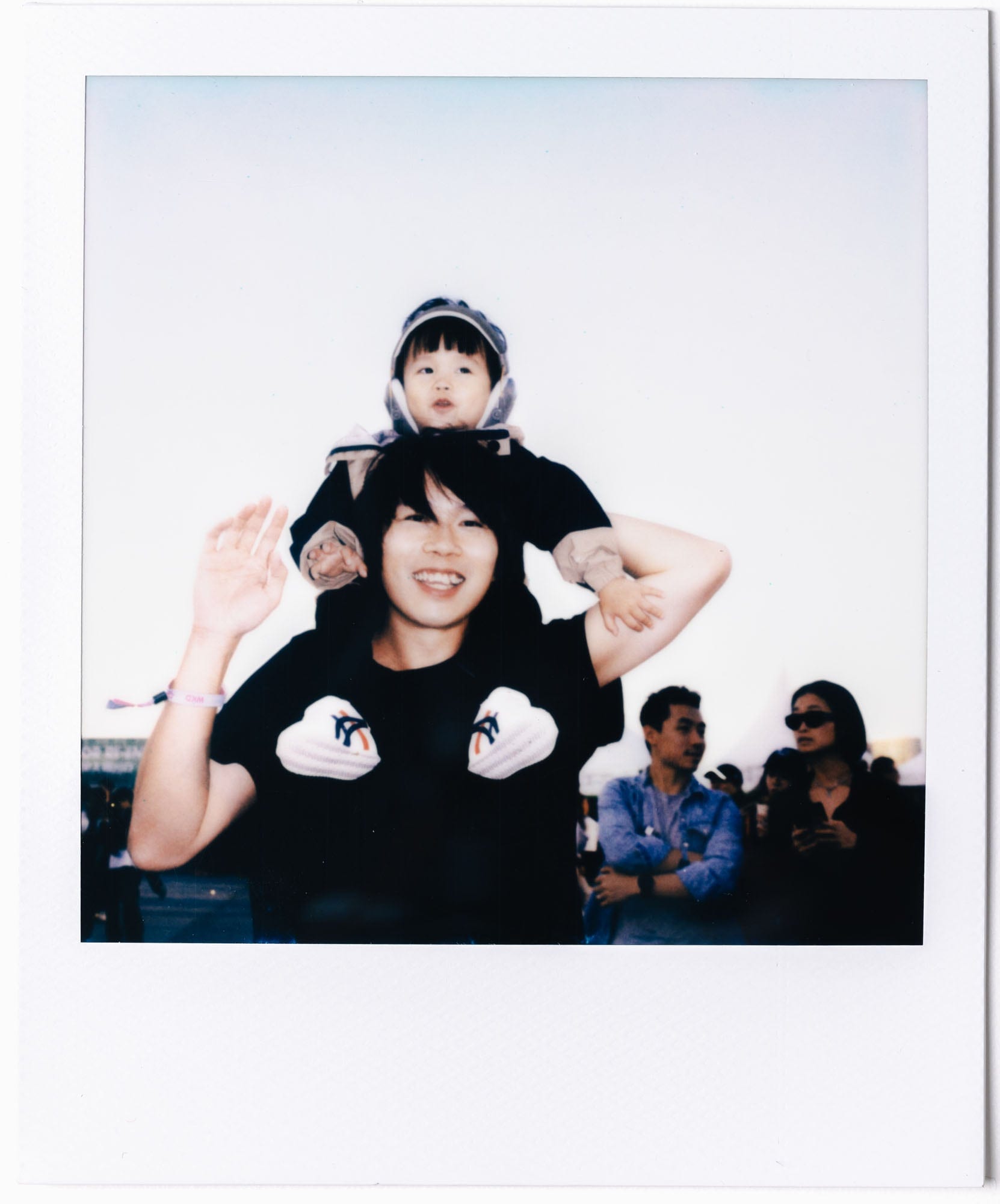 Parent and child at Clockenflap captured on Polaroid film
