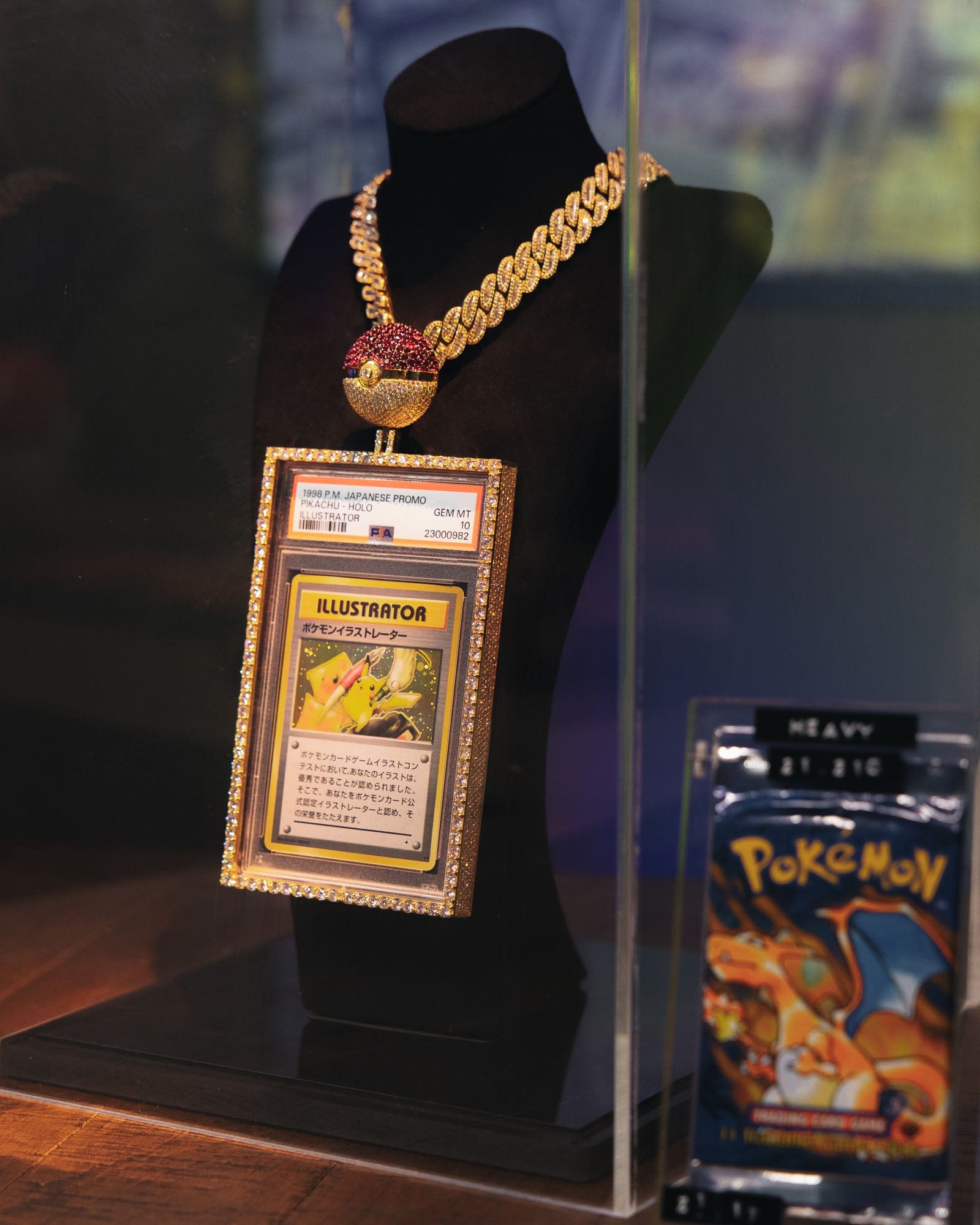 Illustrator Pikachu card displayed on a jeweled Poké Ball necklace