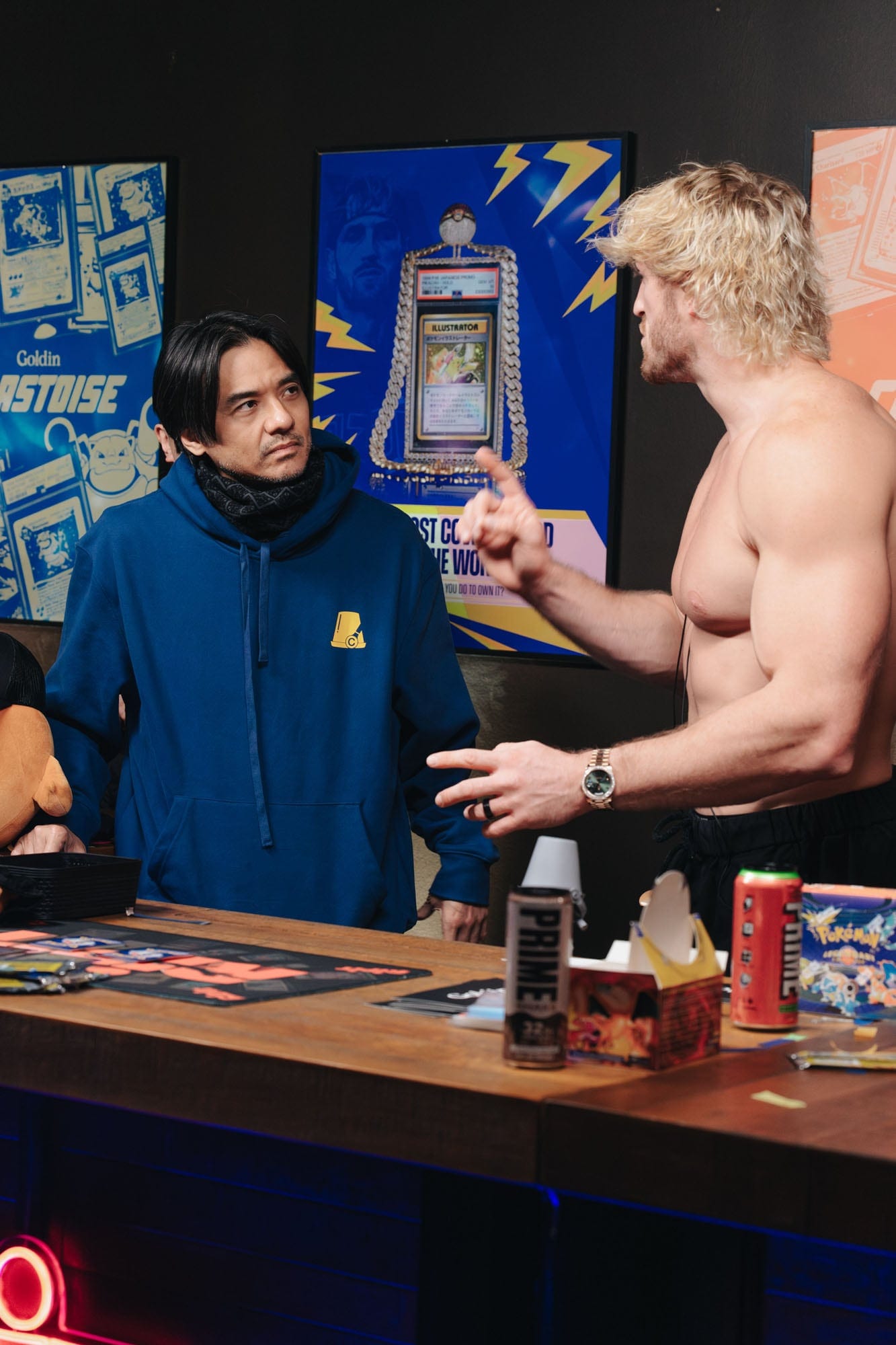 Logan Paul speaking with a guest at the Illustrator Pikachu event