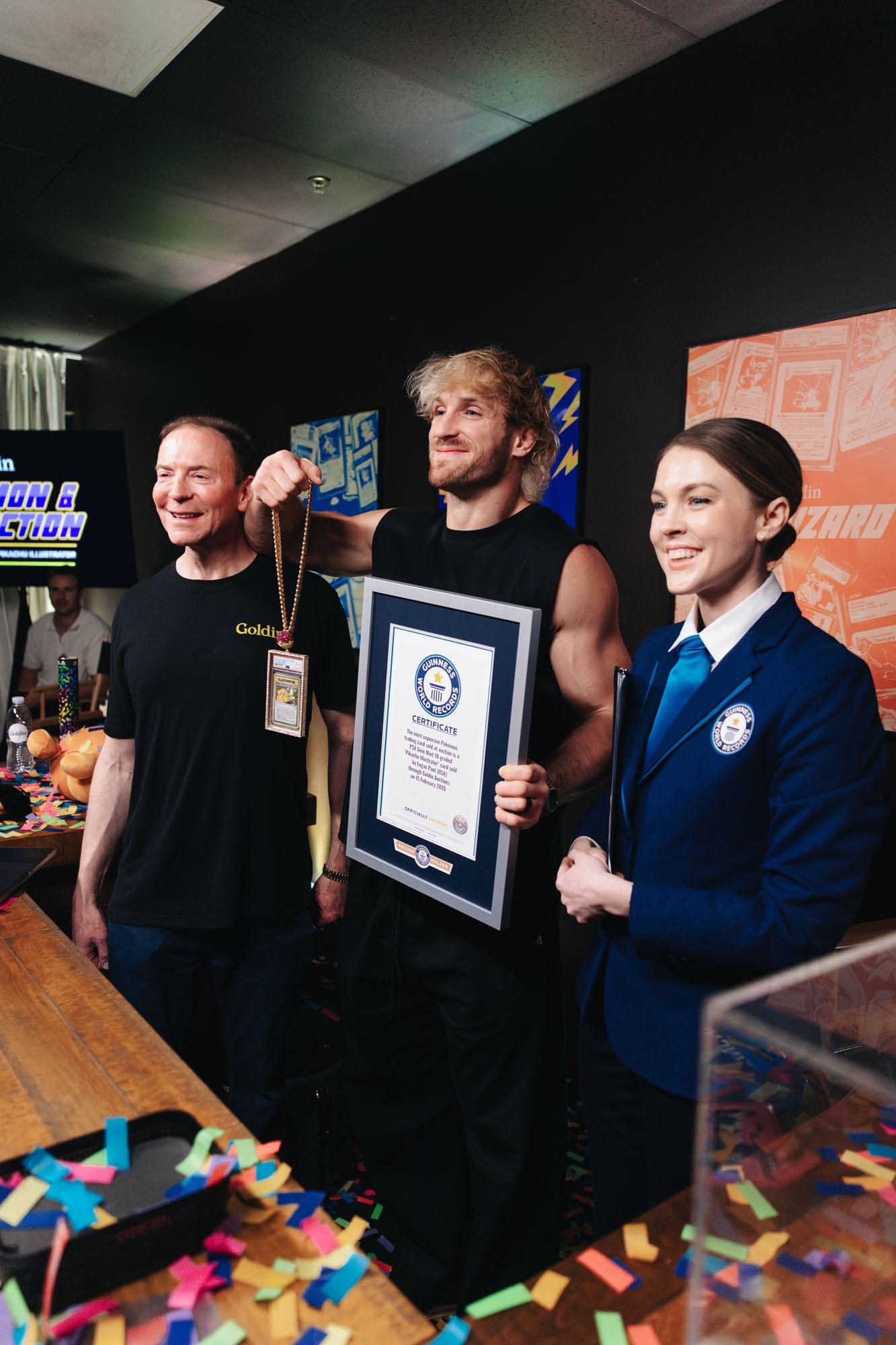 Logan Paul holding the Illustrator Pikachu card beside a Guinness World Records certificate