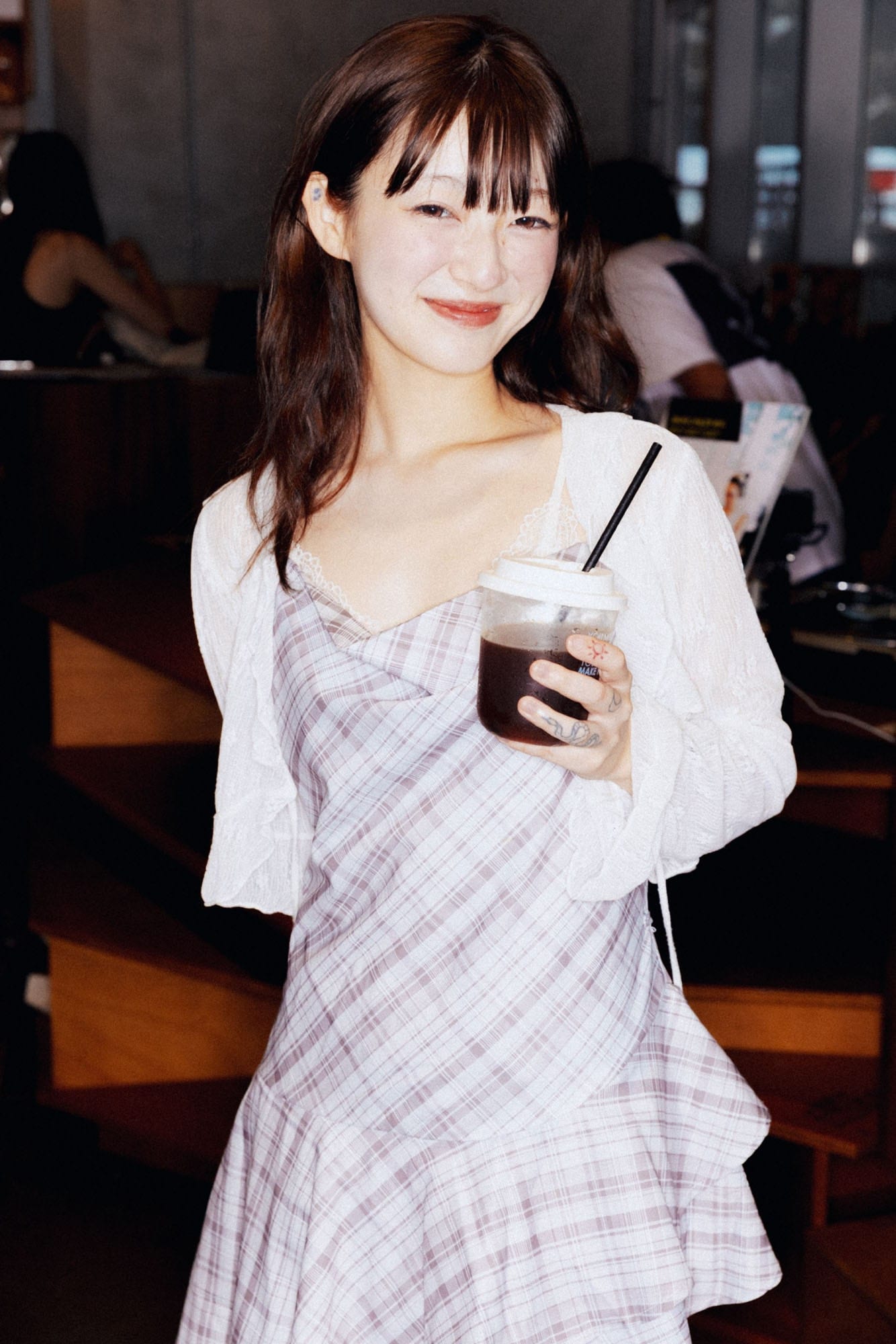 Guest holding a coffee at Grooffee Corner