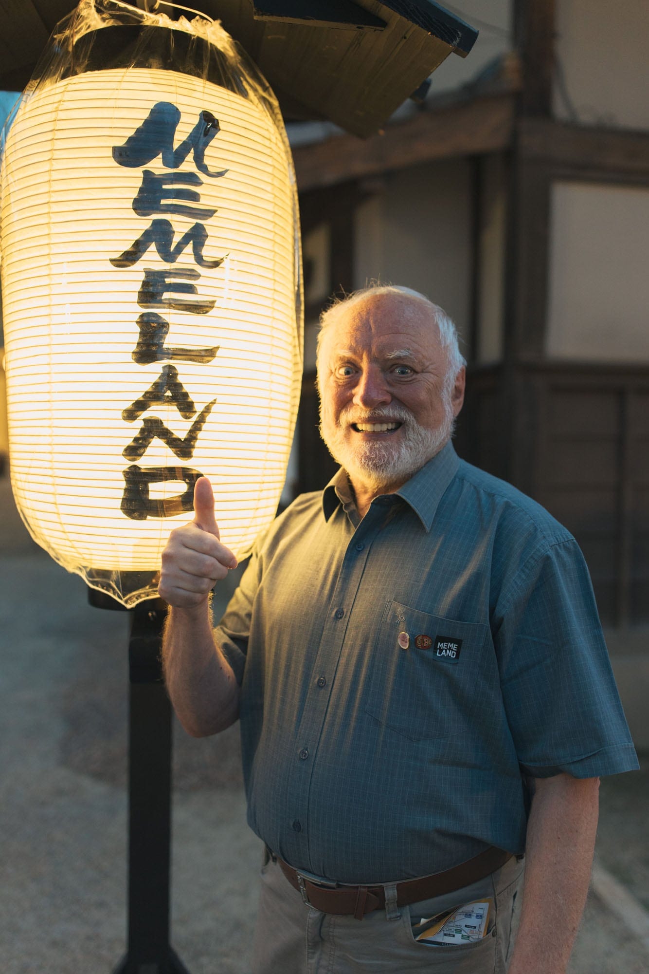 Hide The Pain Harold beside a lantern at the Memeland IVS Kyoto event