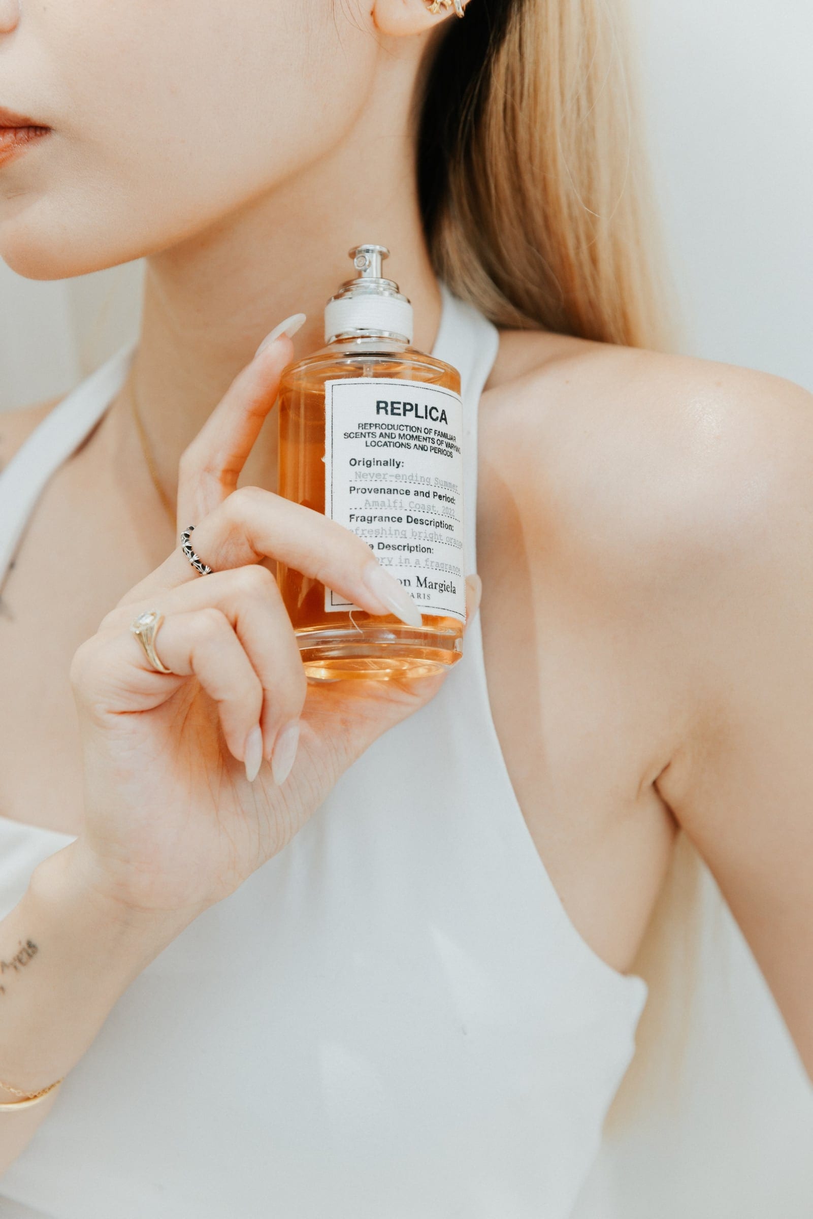 Maison Margiela fragrance bottle held close at the launch