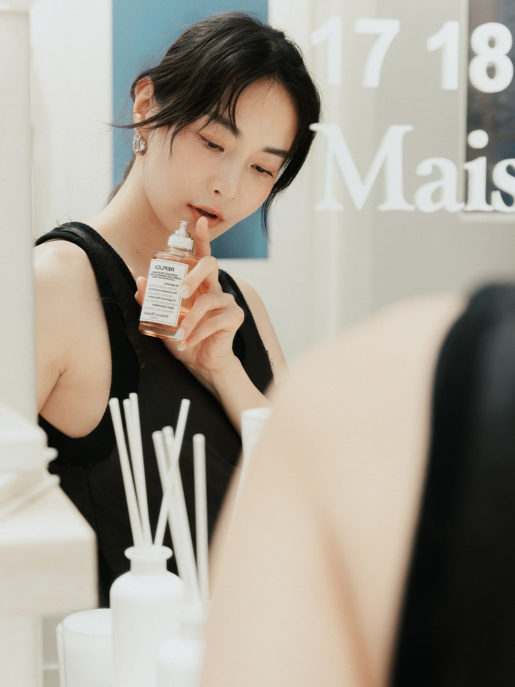 Afa Lee holding Maison Margiela Fragrances at the Never-Ending Summer launch
