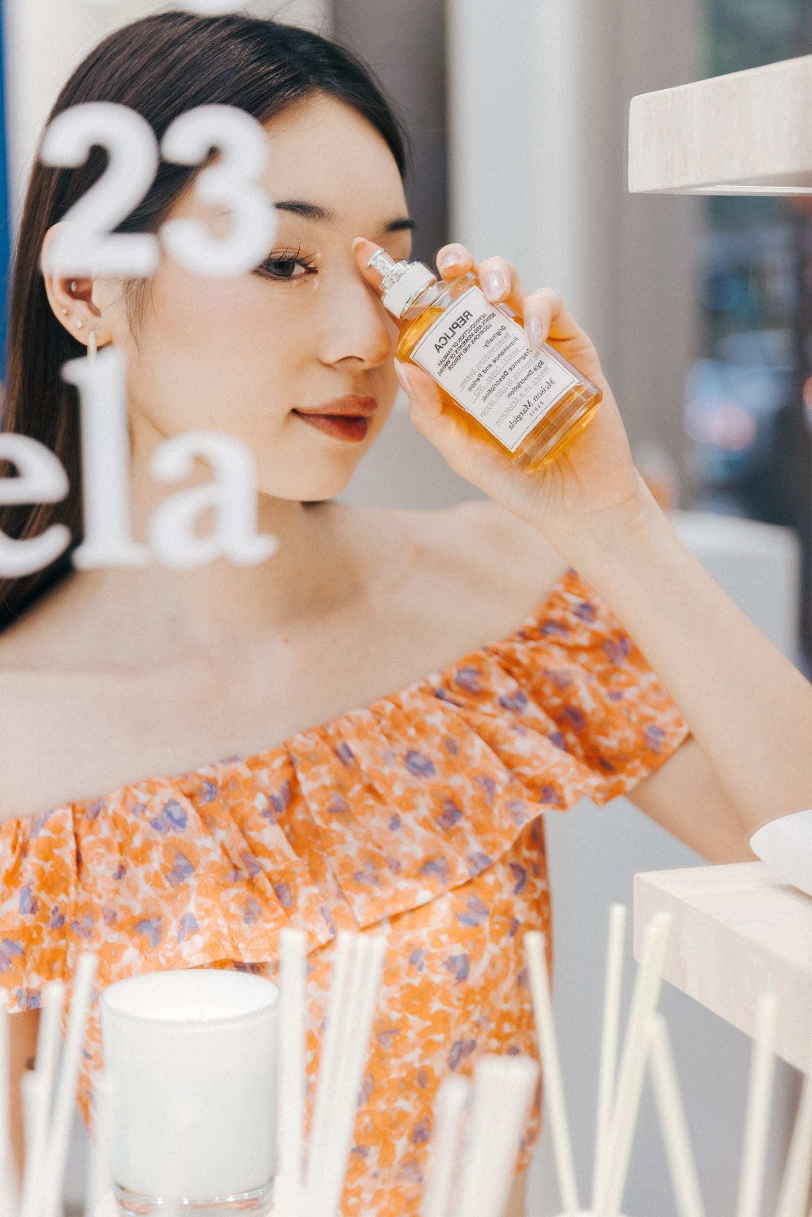 Guest holding Maison Margiela fragrance at the launch
