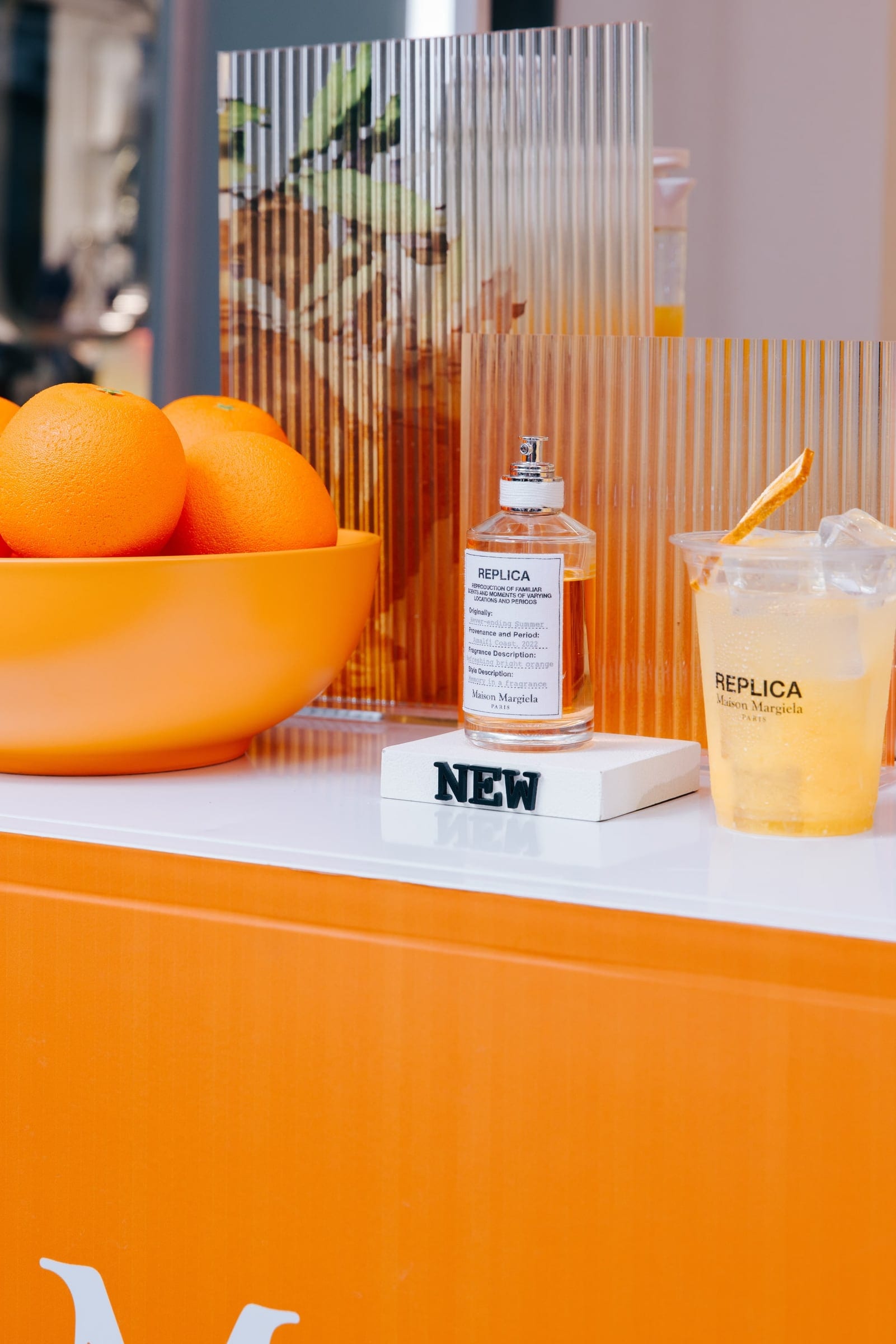 Maison Margiela fragrance and citrus drinks at the bar