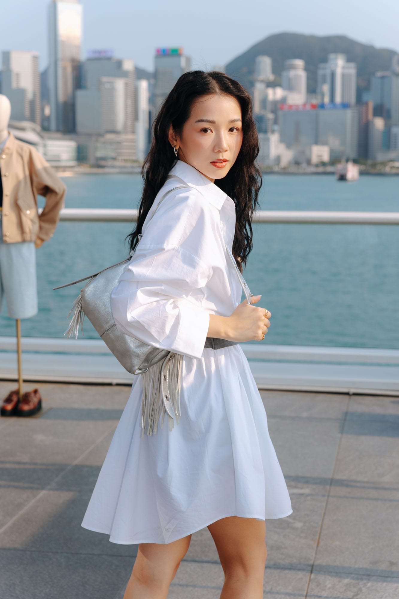 Guest in a white Maje look on the Hong Kong waterfront