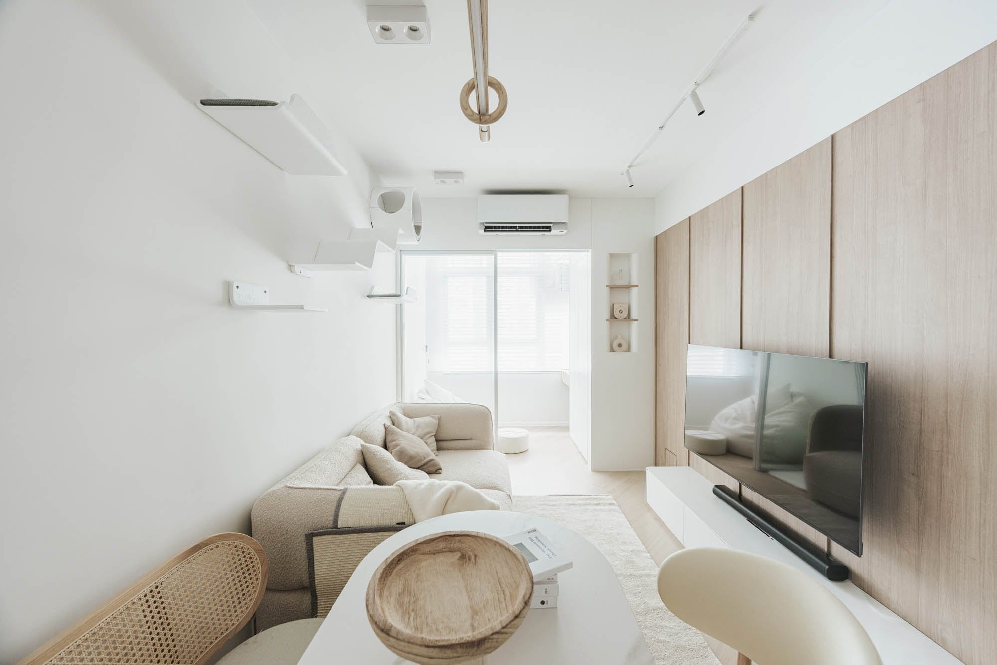 Kai Chuen Court living room with pale timber joinery and soft natural light