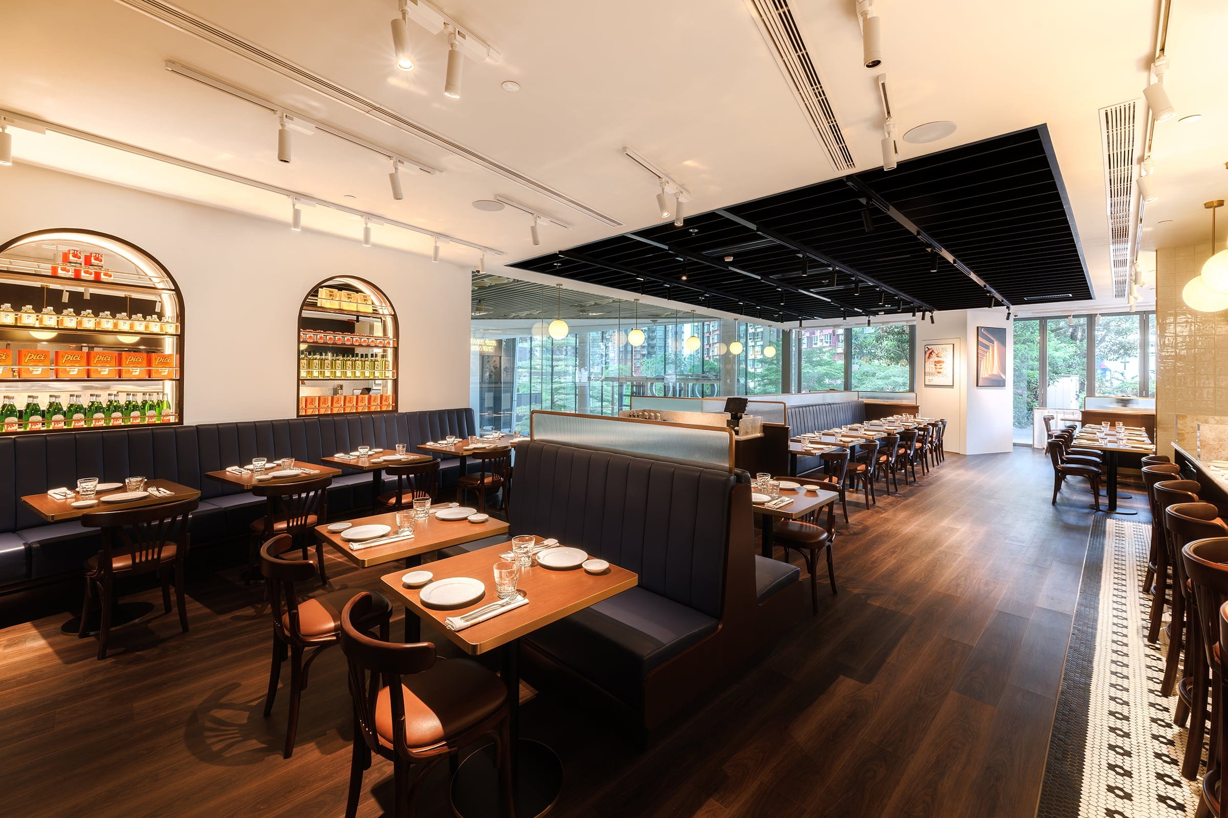 Pici restaurant dining room with banquettes, tables and daylight