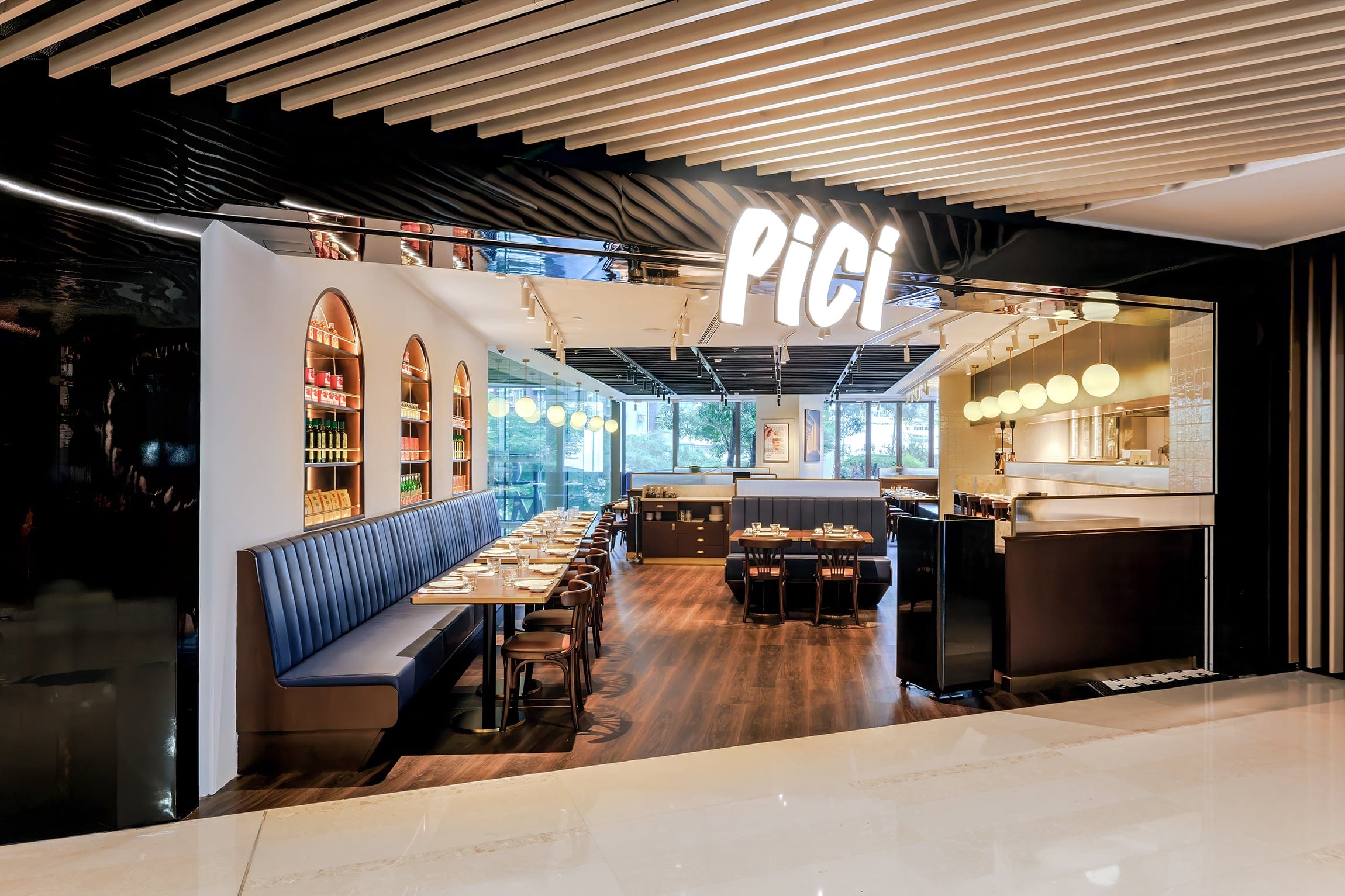 Pici restaurant interior framed by a dark entrance and illuminated dining room