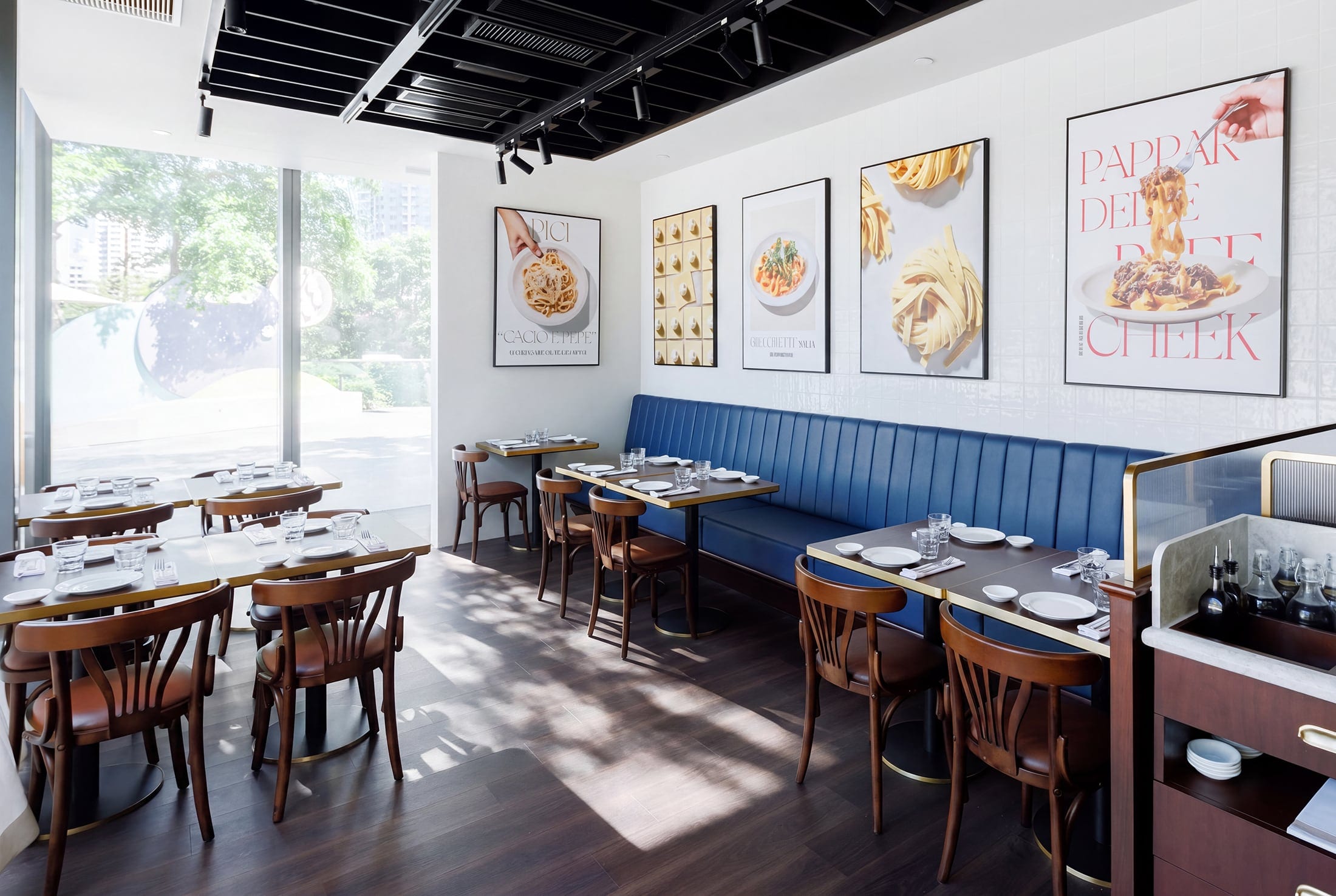 Pici restaurant interior with blue banquette seating and framed artwork
