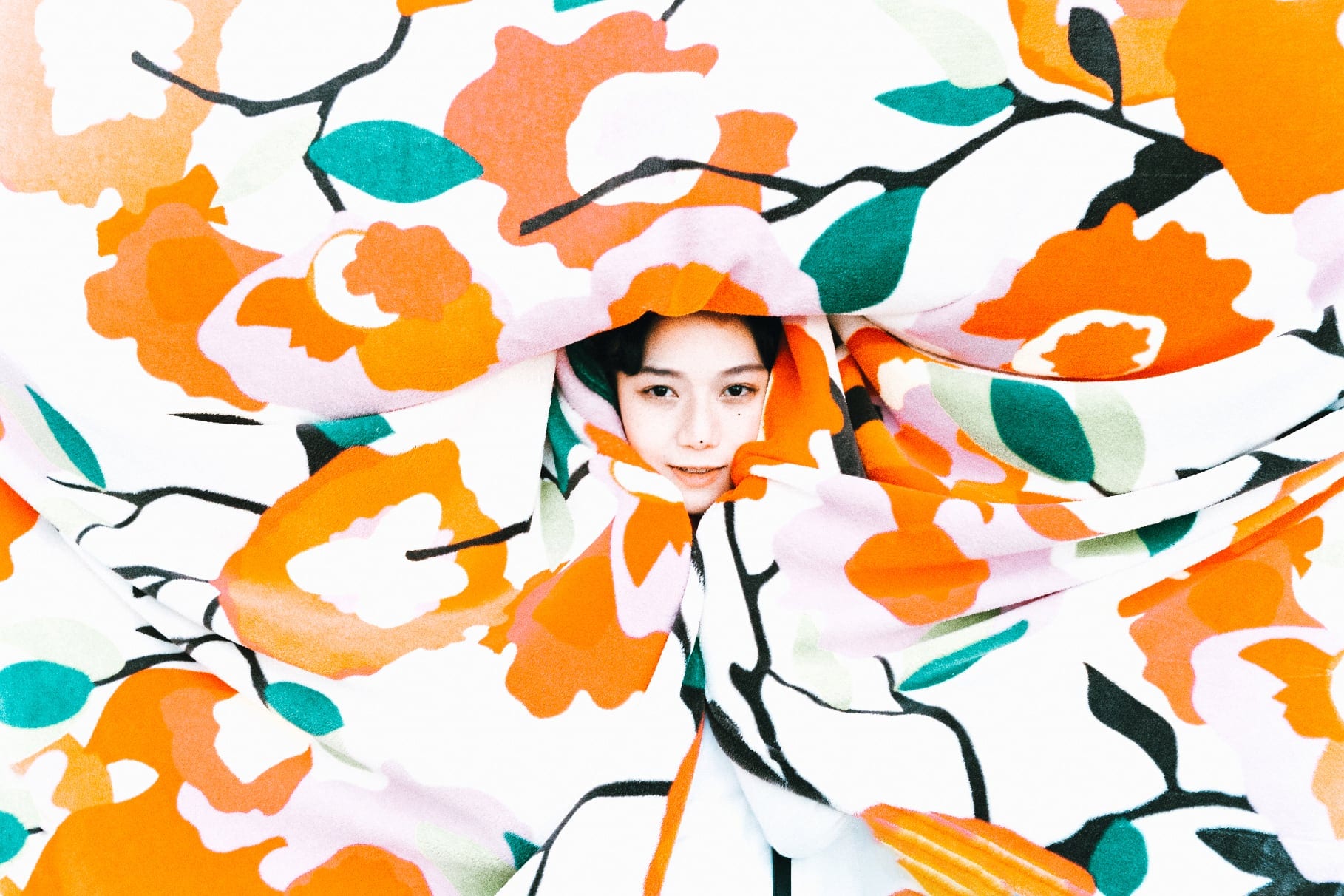 Portrait framed by an orange floral pattern