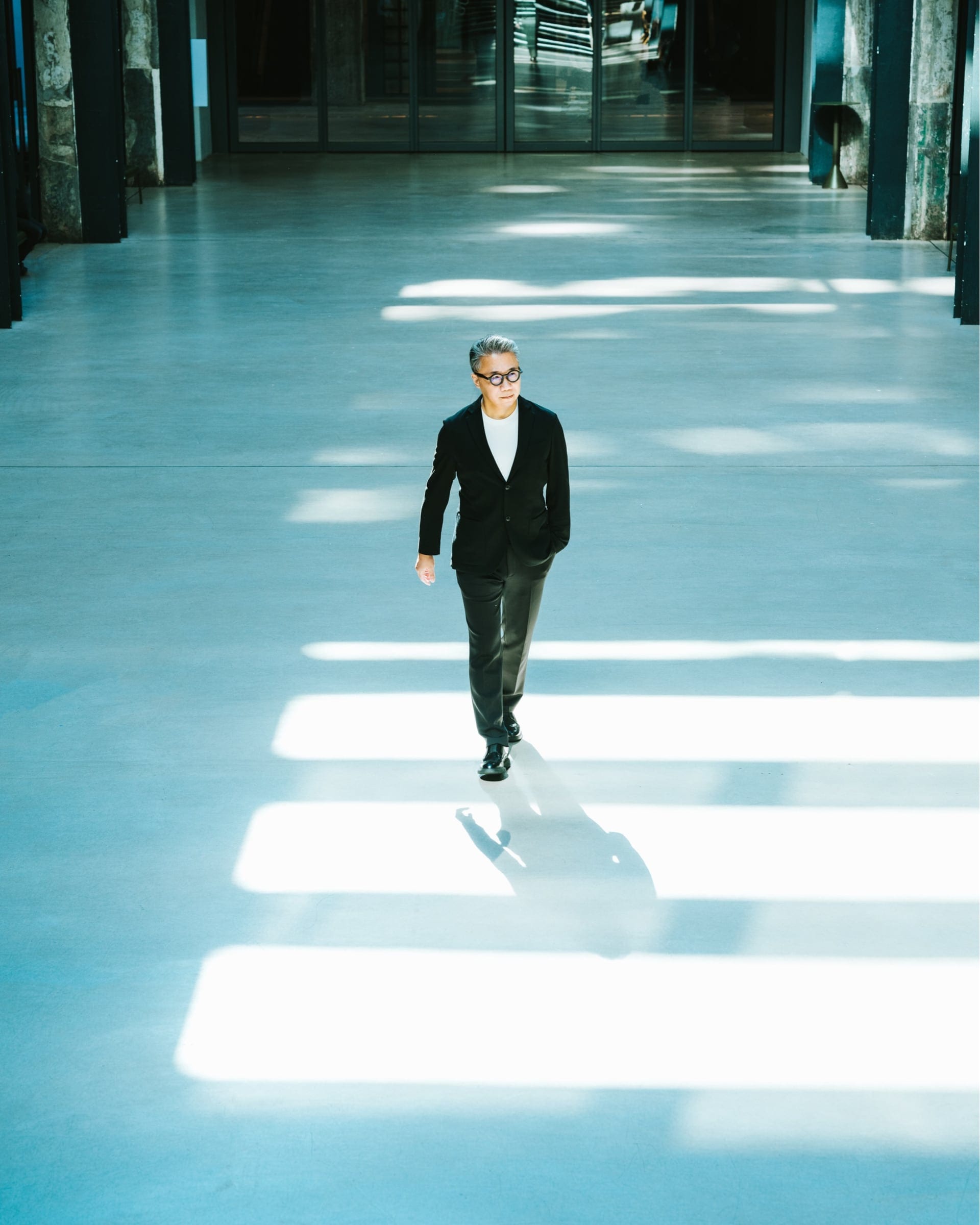 HKTDC portrait of a man walking through a sunlit interior