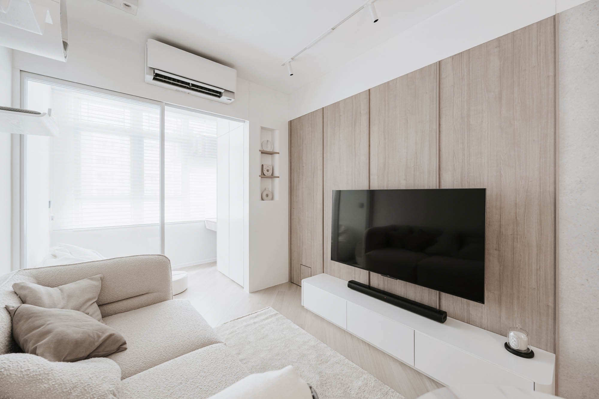 Kai Chuen Court living room with timber television wall and window light