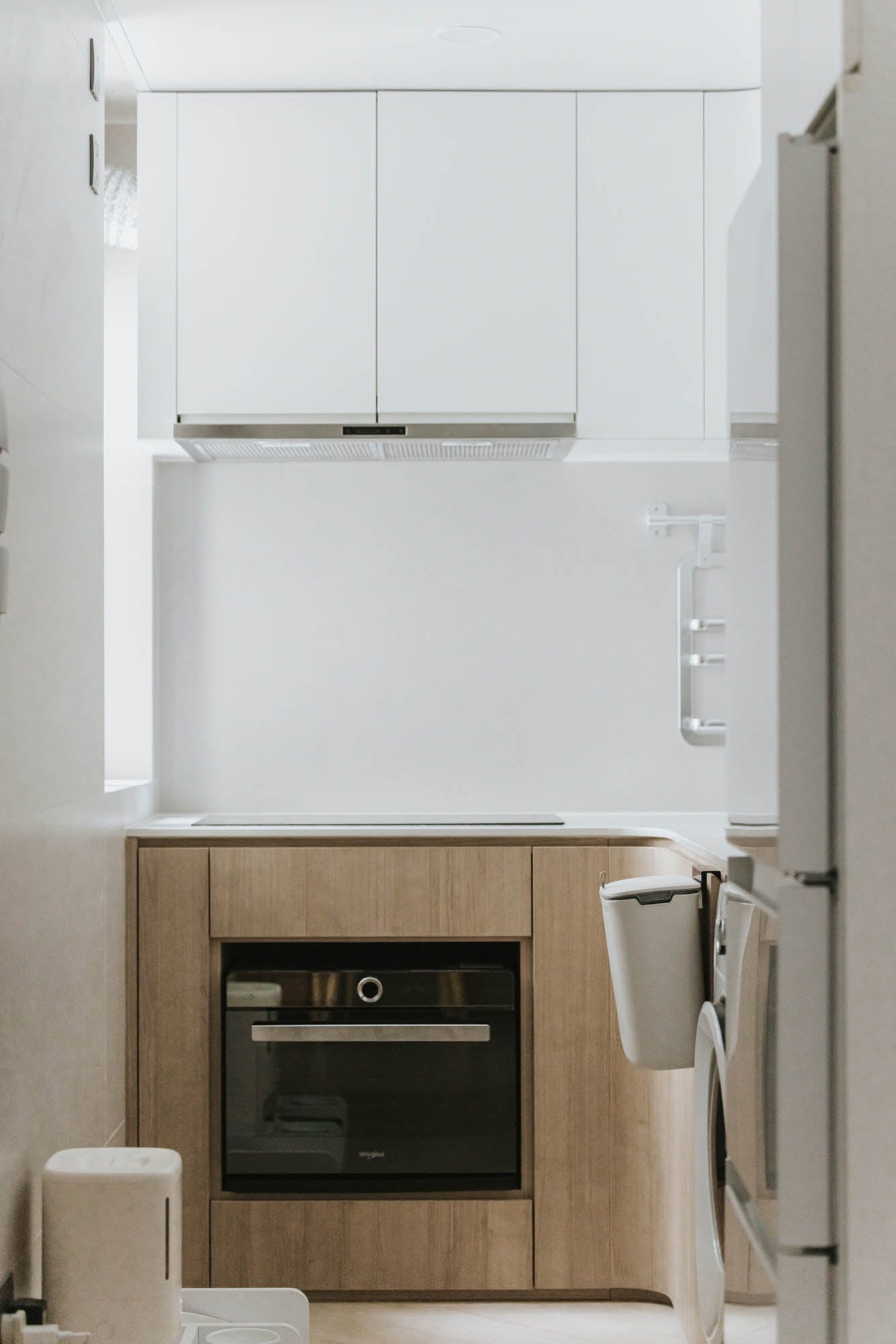 Kai Chuen Court compact kitchen in white and pale timber