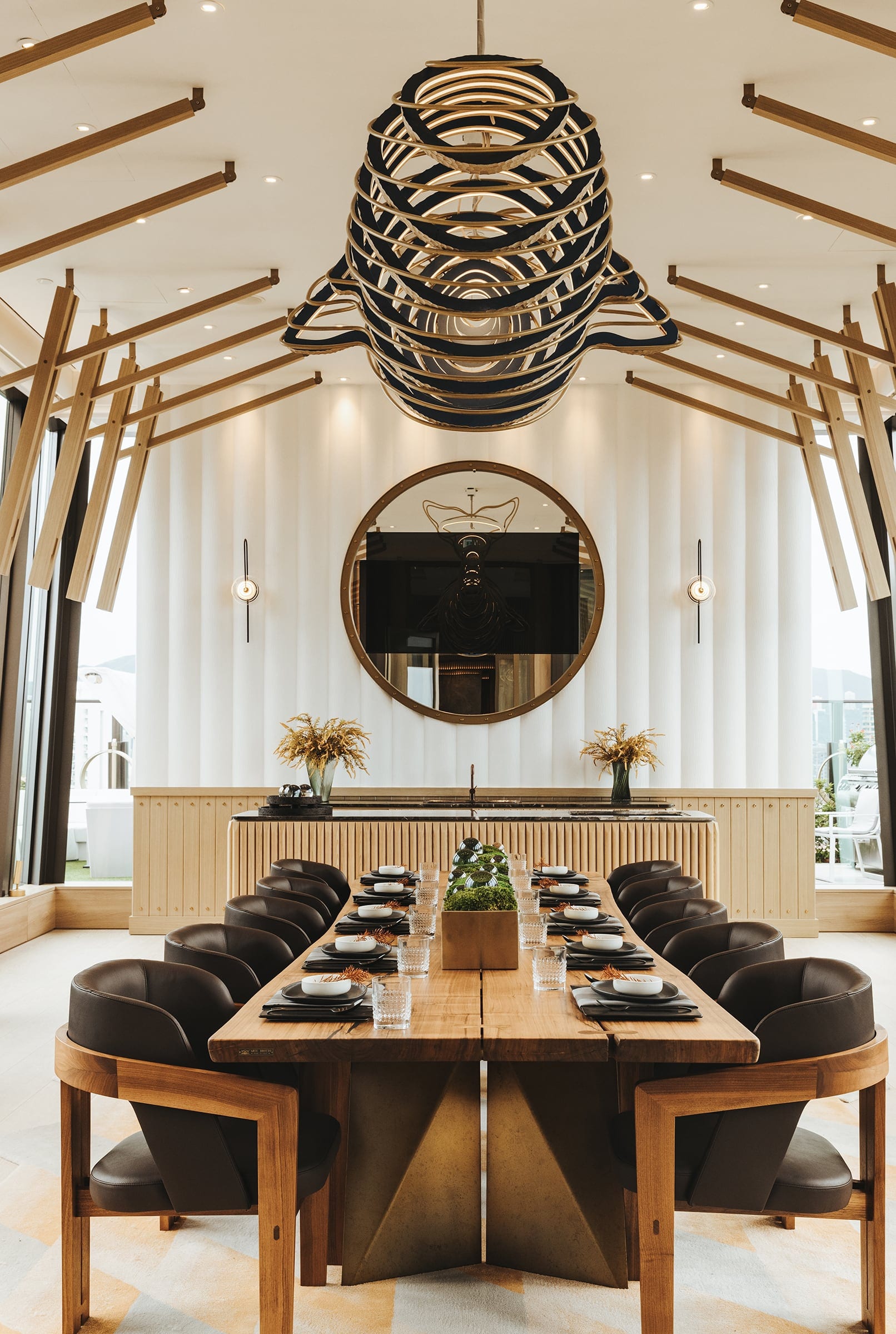 The Vantage sculptural chandelier above a dining table