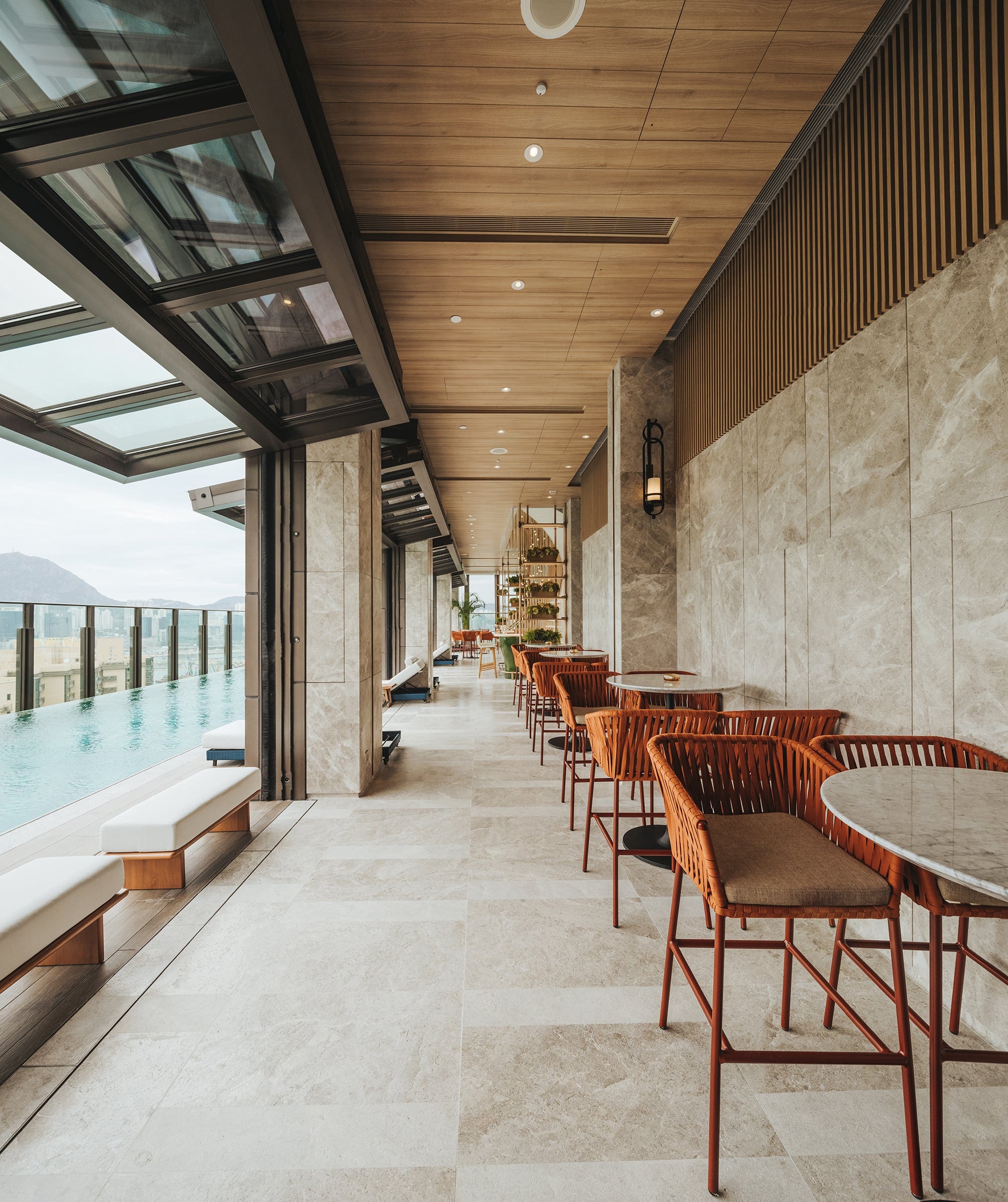 The Vantage poolside terrace with timber ceiling and marble wall