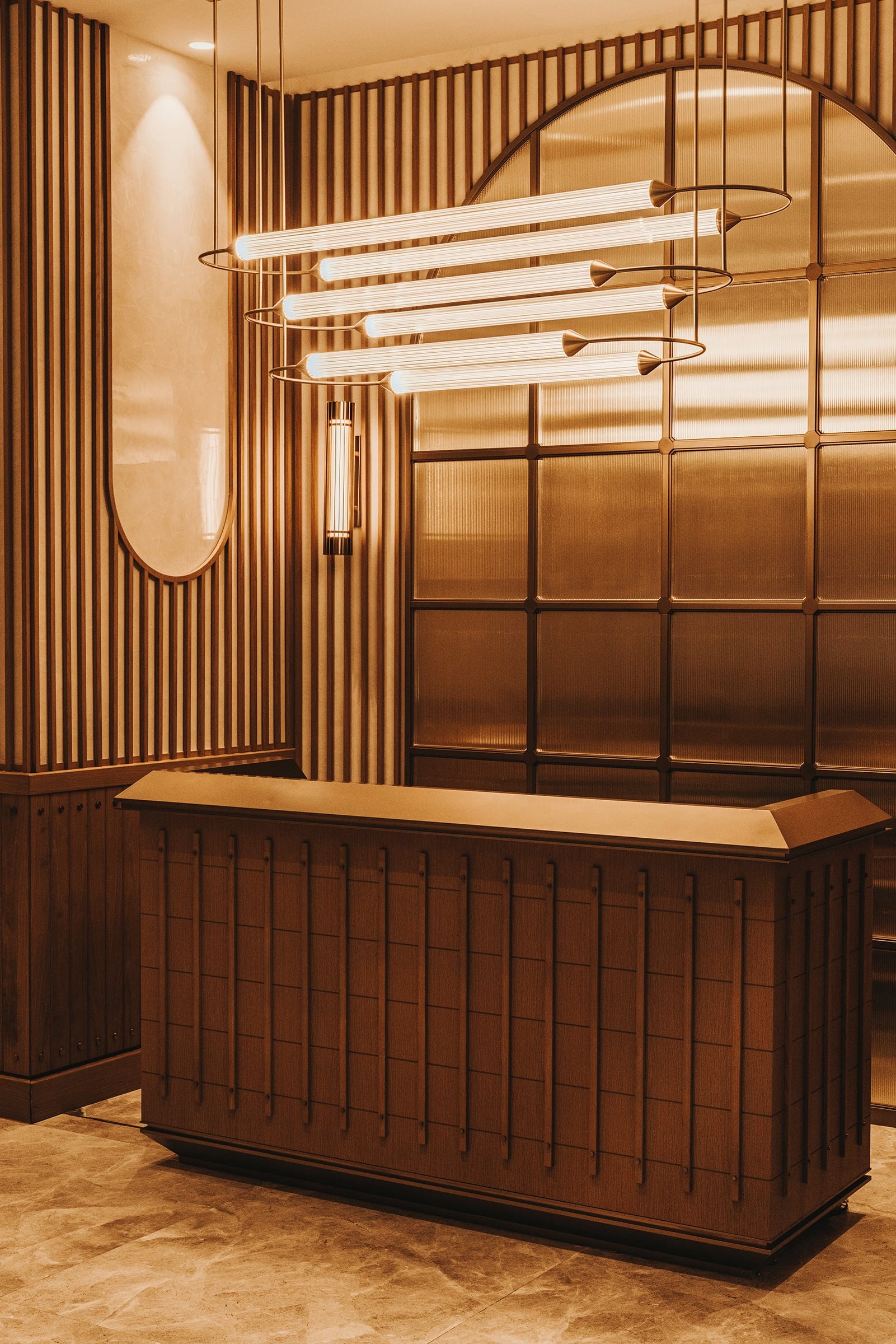The Vantage reception with linear chandelier and timber wall
