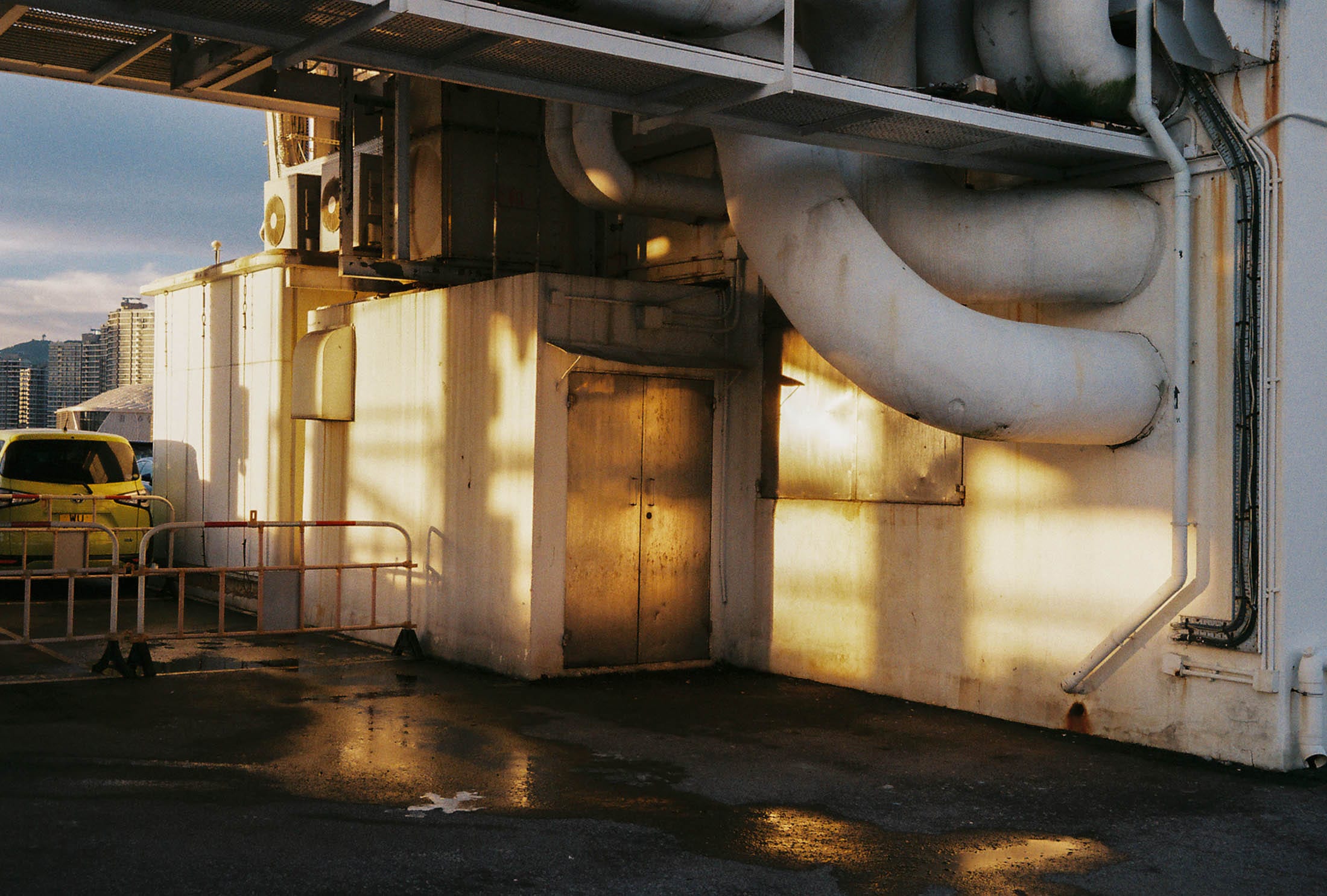 Warm late light on rooftop ducts above the city